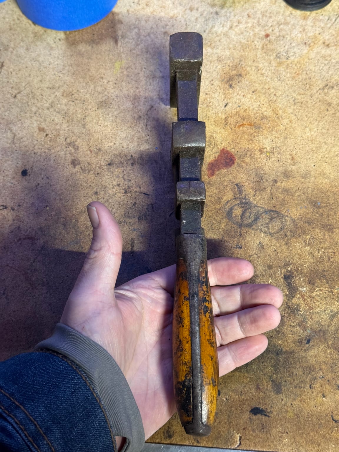 Unidentified antique adjustable wrench as acquired, heavily oxidized with a worn golden wooden handle
