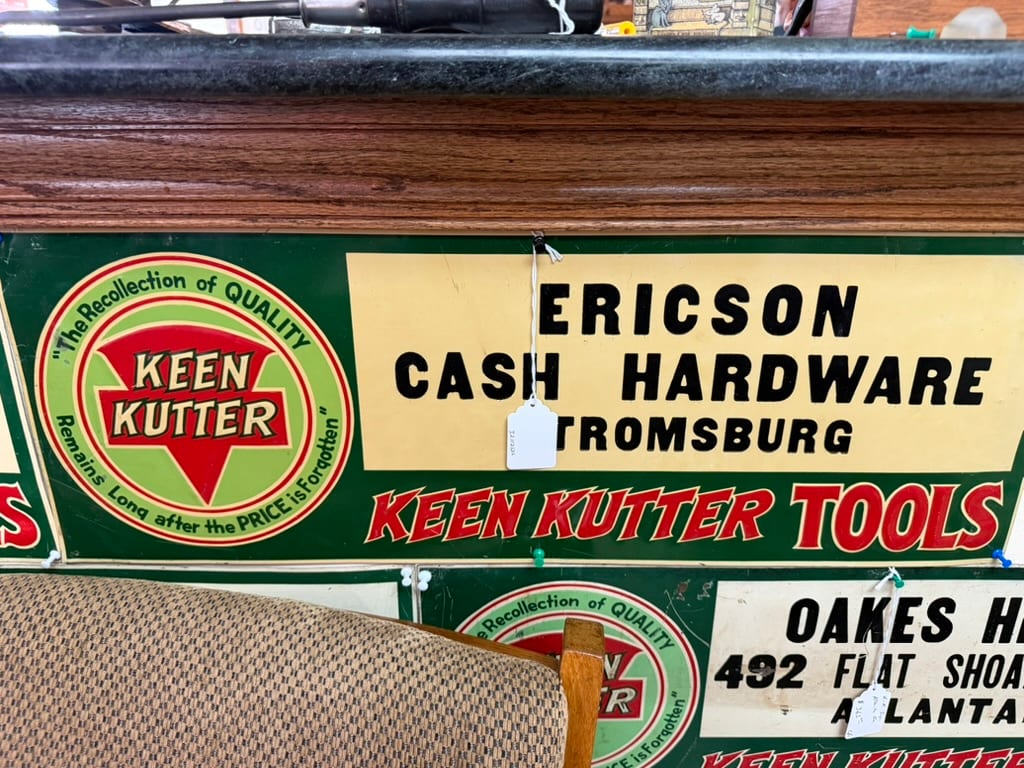 Vintage green Keen Kutter dealer sign with a white field customized for an individual hardware dealer