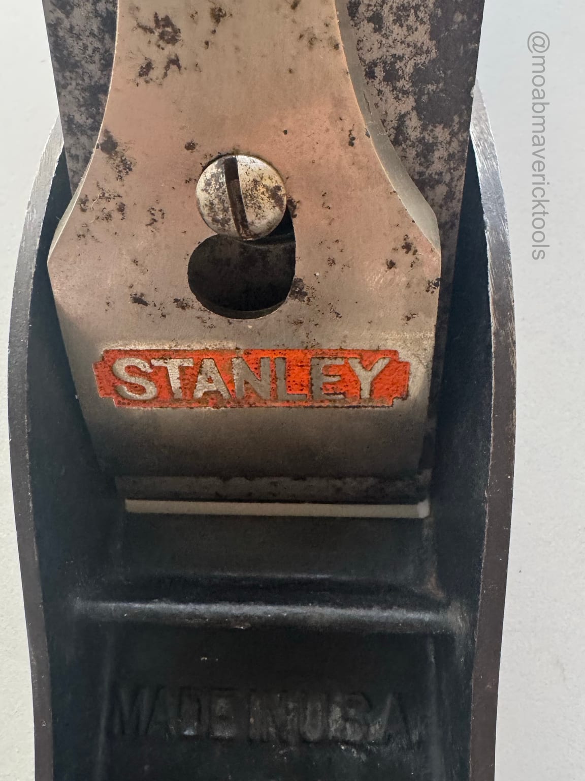 Close view of the worn orange Stanley lever cap and dark wooden knob on the more visibly aged No. 5 jack plane