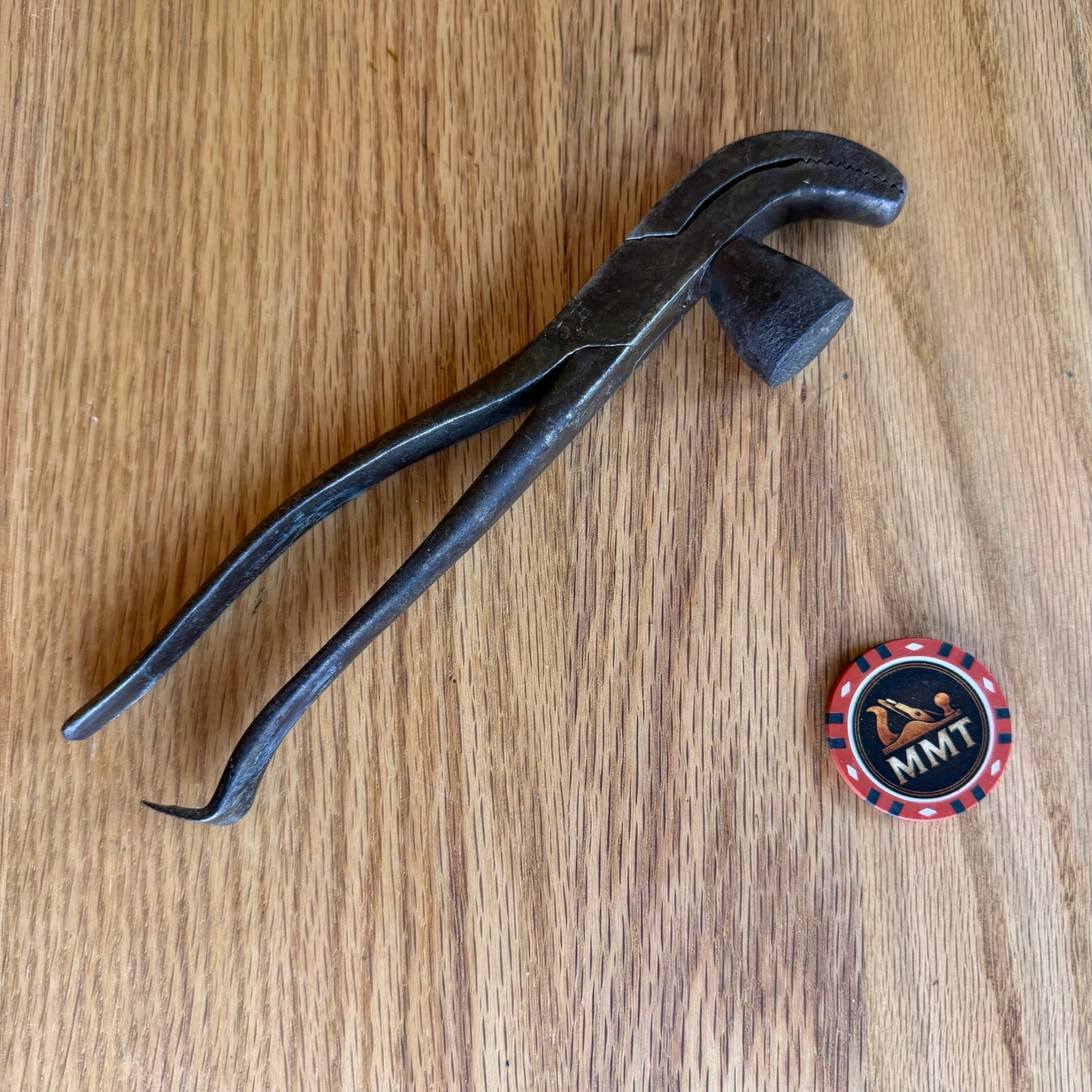 Antique Frank W. Whitcher lasting pliers with curved serrated jaws, integral hammer, long handles, and tack-pulling claw