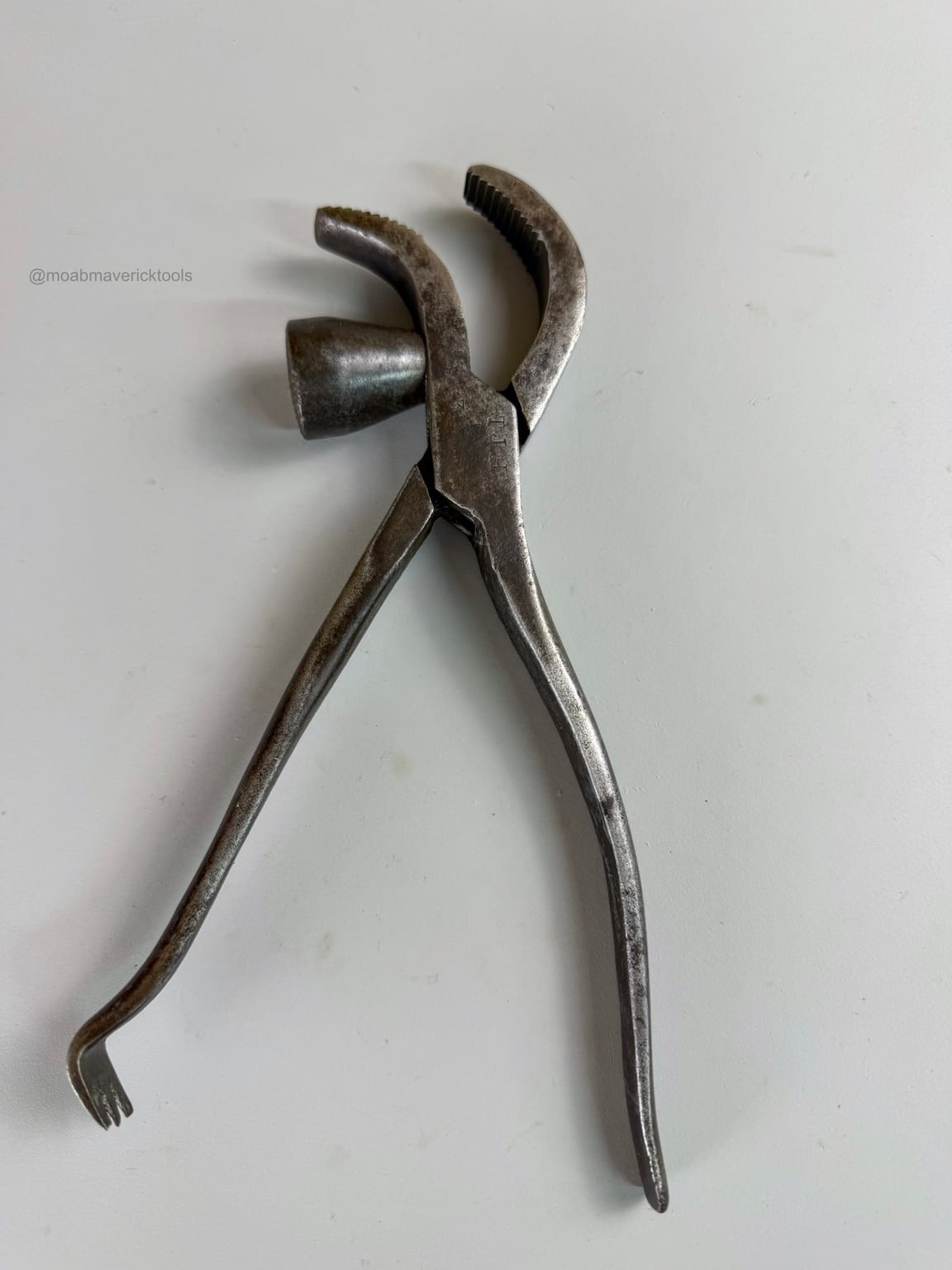 Antique Whitcher lasting pliers opened to show the curved serrated jaws, projecting hammer, long handles, and tack-pulling claw