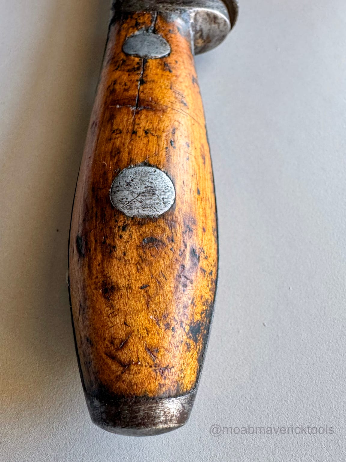 Original golden wooden wrench handle after cleaning and stabilization with wear and age marks preserved