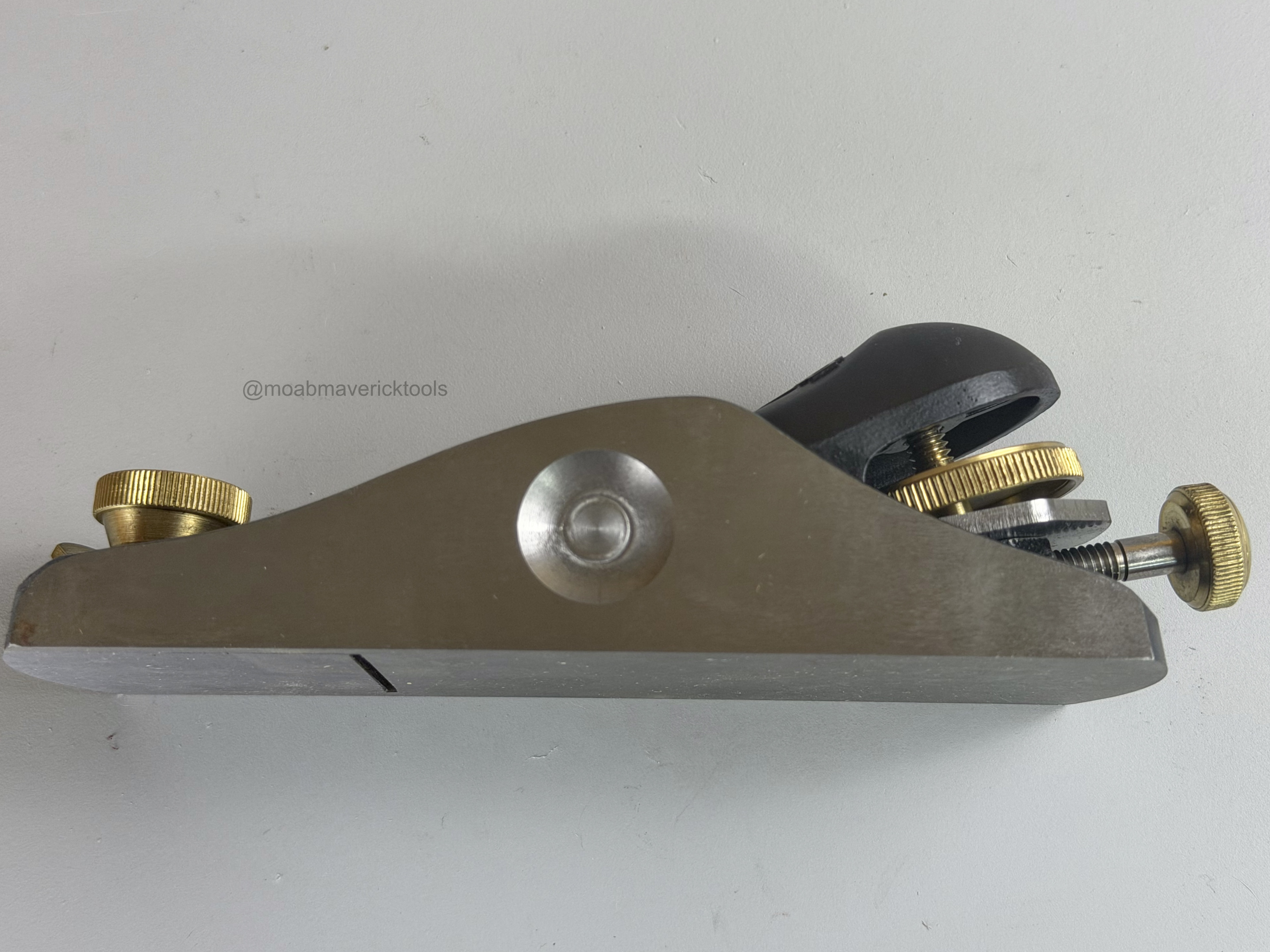 Opposite side view of Stanley No. 60½ block plane showing blade and brass adjustment hardware